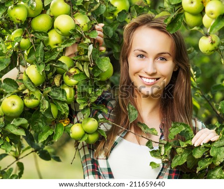 http://thumb1.shutterstock.com/display_pic_with_logo/1129805/211659640/stock-photo-woman-in-an-apple-tree-garden-during-the-harvest-season-young-smiling-beautiful-woman-is-standing-211659640.jpg
