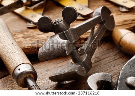 old clamp on aged carpenter workbench - stock photo