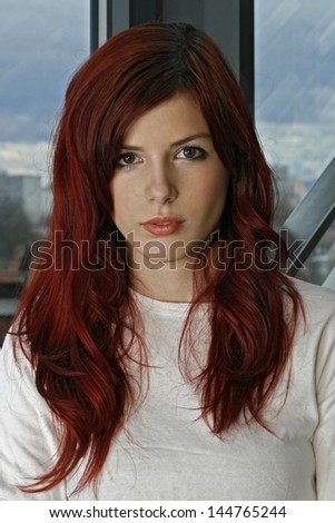 http://thumb1.shutterstock.com/display_pic_with_logo/1180193/144765244/stock-photo-beautiful-young-business-woman-with-red-hair-144765244.jpg