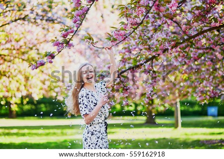 stock photo beautiful young woman enjoying sunny day in park during cherry blossom season on a nice spring day 559162918
