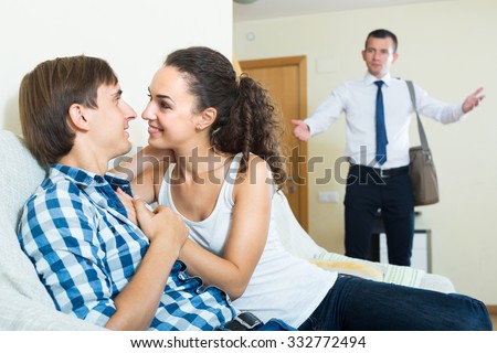 thumb1.shutterstock.com/display_pic_with_logo/124564/332772494/stock-photo-upset-man-coming-home-and-seeing-girlfriend-cheating-on-him-332772494.jpg