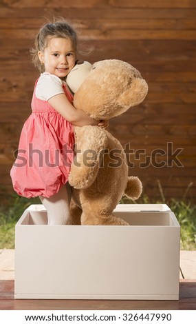 girl hugging huge teddy bear