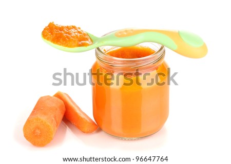 Jar of baby puree with carrot and spoon isolated on white ...