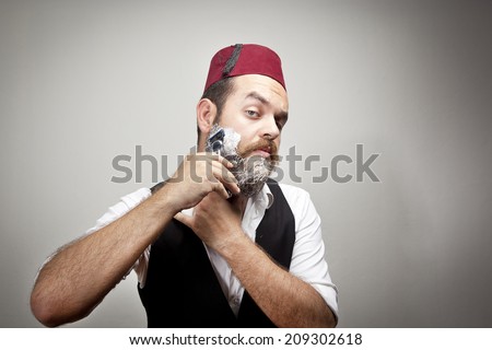 stock-photo-man-in-traditional-turkish-hat-and-dress-kabadayi-unhappy-shaving-209302618.jpg