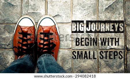 Big journeys begin with small steps, Inspiration quote, shoes on street - stock photo