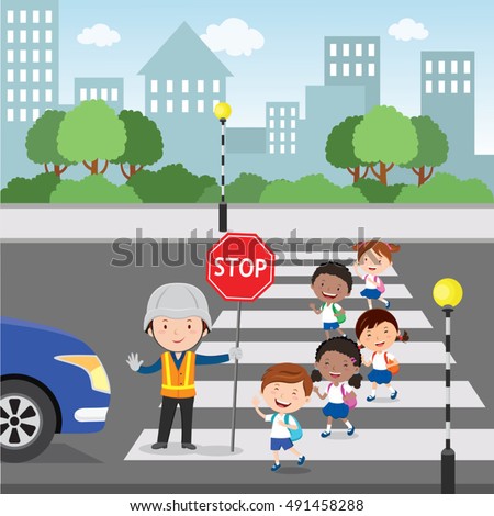Traffic guard helping school kids crossing road by holding a stop sign Traffic guard helping school kids crossing road by holding a stop sign