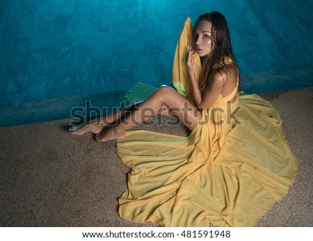 stock photo gorgeous fashion brunette woman in elegant yellow dress sitting beside swimming pool at luxurious 481591948