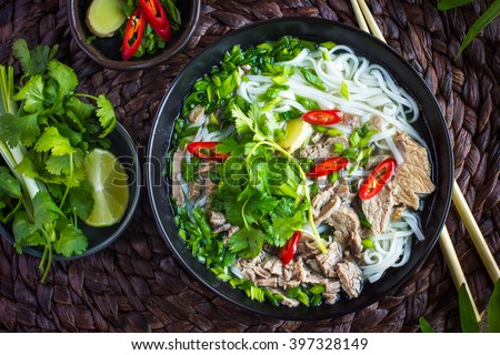 Traditional Vietnamese soup Pho with beef and rice noodles, top view