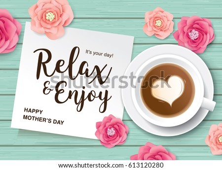 Flat lay style mother's day greeting card with coffee, flowers and white note paper on wooden table. Flat lay style mother's day greeting card with coffee, flowers and white note paper on wooden table.