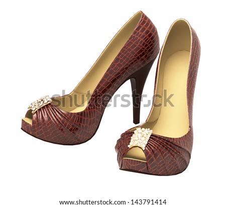 Crocodile leather women's shoes with high heels close up on a light