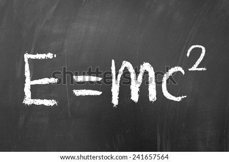 equals mc squared drawn with white chalk on blackboard - stock photo