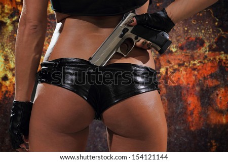 stock-photo-sexy-woman-with-gun-over-grunge-background-154121144.jpg