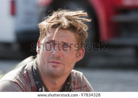  of grungy unshaven man outdoors during the daytime. - stock photo