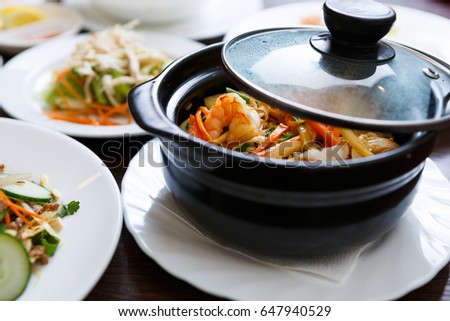 Delicious Vietnamese seafood dish in bowl.Shrimps with fresh vegetables & rice.Traditional Asian cuisine in restaurant.Natural gourmet menu in cafe.Good diet with healthy ingredients.Food from Vietnam