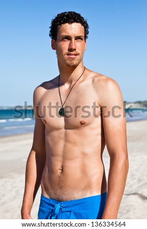 Young handsome muscular man in a bathing suit hanging on the beach ... Young handsome muscular man in a bathing suit hanging on the beach ...