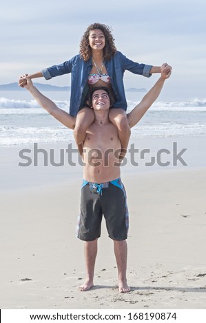 http://thumb1.shutterstock.com/display_pic_with_logo/519892/168190874/stock-photo-happy-young-woman-sits-on-boyfriend-s-shoulders-as-they-play-on-beautiful-beach-168190874.jpg