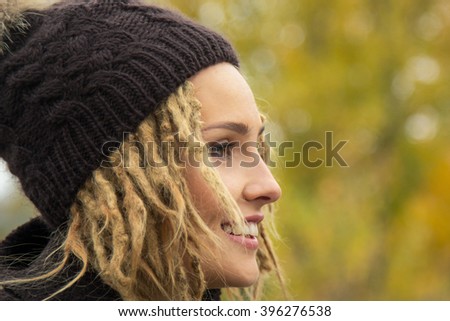 ... with a dreadlocks hairstyle in coat and knitted cap - stock photo ... with a dreadlocks hairstyle in coat and knitted cap - stock photo