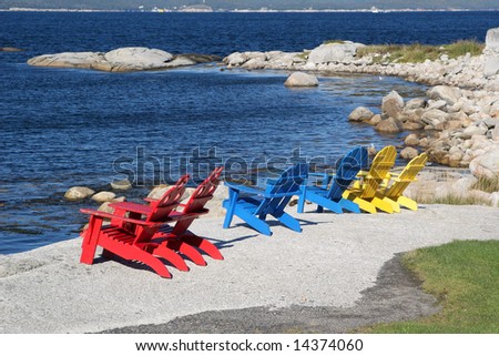 row of wooden Adirondack chairs on the granite rocks overlooking the 