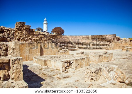 The ancient amphitheatre in Paphos with lighthouse on the background 