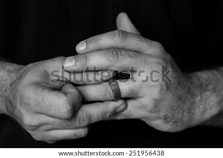 man twirling wedding ring