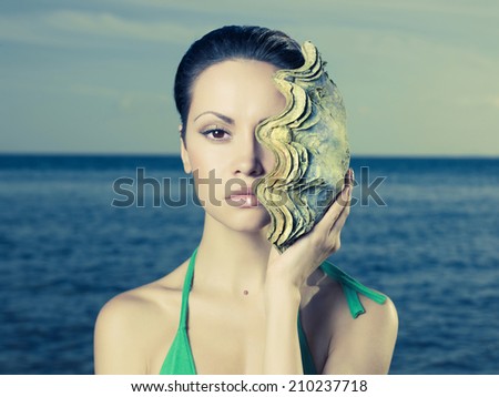 Portrait of a beautiful young lady with a large <b>sea shell</b> - stock photo - stock-photo-portrait-of-a-beautiful-young-lady-with-a-large-sea-shell-210237718