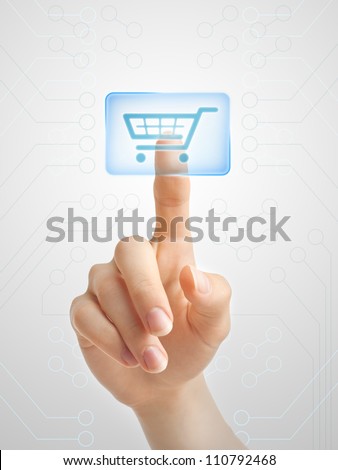 Hand pushing virtual symbol of online shopping. - stock photo