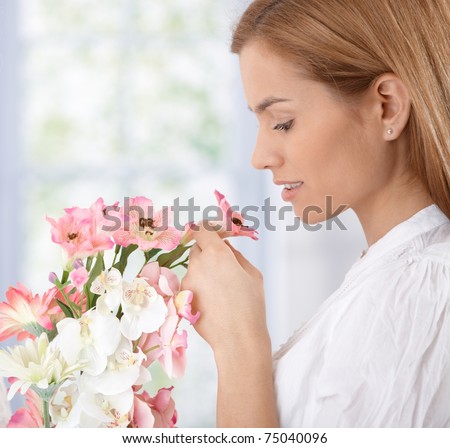 http://thumb1.shutterstock.com/display_pic_with_logo/65566/65566,1302532534,14/stock-photo-beautiful-young-woman-smelling-flowers-75040096.jpg