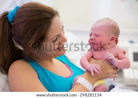 stock-photo-mother-giving-birth-to-a-baby-newborn-baby-in-delivery-room-mom-holding-her-new-born-child-after-298281134.jpg