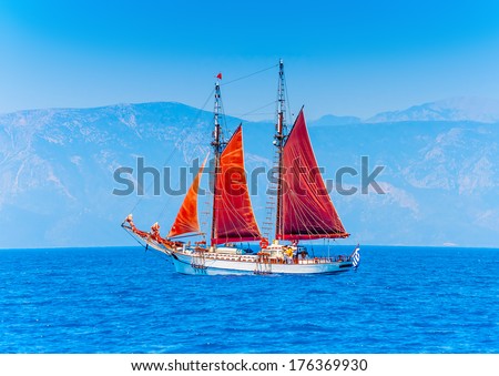 Old classic wooden boat with red sails, during a Classic Boats Regatta 
