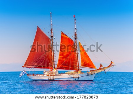 Old classic wooden boat with red sails, during a Classic Boats Regatta ...