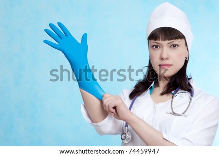 Application de la gomme laque !!! - Page 2 Stock-photo--pretty-young-nurse-putting-blue-latex-medical-glove-on-white-background-74459947