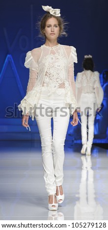  - stock-photo-barcelona-may-a-model-walks-on-the-yolan-cris-catwalk-during-the-barcelona-bridal-week-runway-105279128