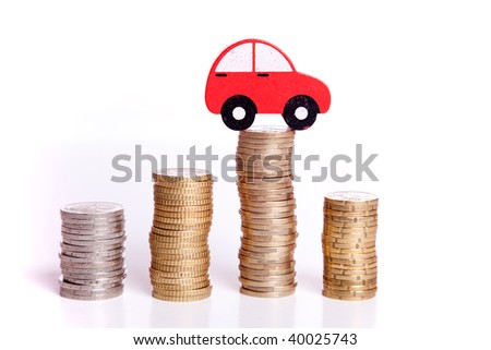 red car over a lot of stacked coins red car over a lot of stacked coins