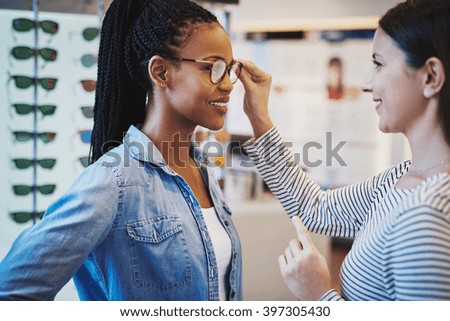 optometrist eyeglasses helping client frames purchase pair african try pretty shutterstock