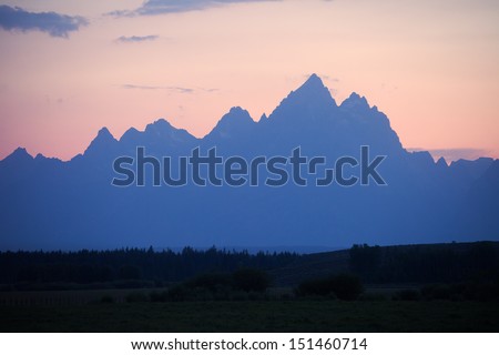  - stock-photo-silhouette-of-grand-teton-at-sunset-with-red-sky-151460714