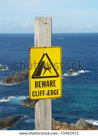 stock-photo-beware-of-cliff-edge-sign-at-booti-booti-national-park-of-australia-73482451.jpg