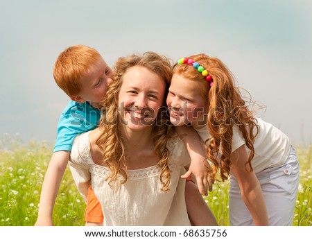 mother with children goes on field - stock photo