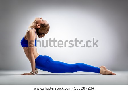 photo a posing yoga stock young poses  beautiful  background on studio yoga logo  gray