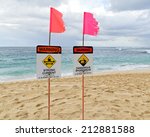 signs on sunset beach warn off...