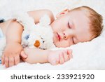 cute baby sleeping with teddy