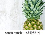 pineapple on white wooden...