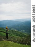 Small photo of Woman talking picture of landscape on Doi Chang Moob viewpoint. This place locateed in Chiang Rai, Thailand.