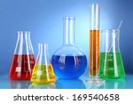 stock-photo-test-tubes-with-colorful-liquids-on-blue-background-169540658.jpg