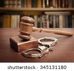 stock-photo-gavel-and-handcuffs-on-wooden-background-345131180.jpg