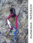 Small photo of Red carabiner with safety rope climber wearing an old rusty hook