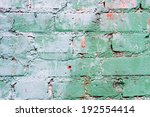 Small photo of Textured old green wall of brick with traces of rubbing