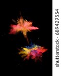 Small photo of Multi cloud blasting powder paint and flour combined, explode in front of a black background to give off fantastic multi color forms.