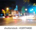 Small photo of Blur traffic light on the road during the night background. Traffic intersection when the traffic jam. Dangerous,warning signal,semaphore driving.