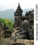 Small photo of headless buddha statue in the ninth century mahayana buddhist temple of borobodur, in magelang, java, indonesia