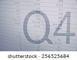 Small photo of Inscription "Q4" on PC screen. Financial data as background.